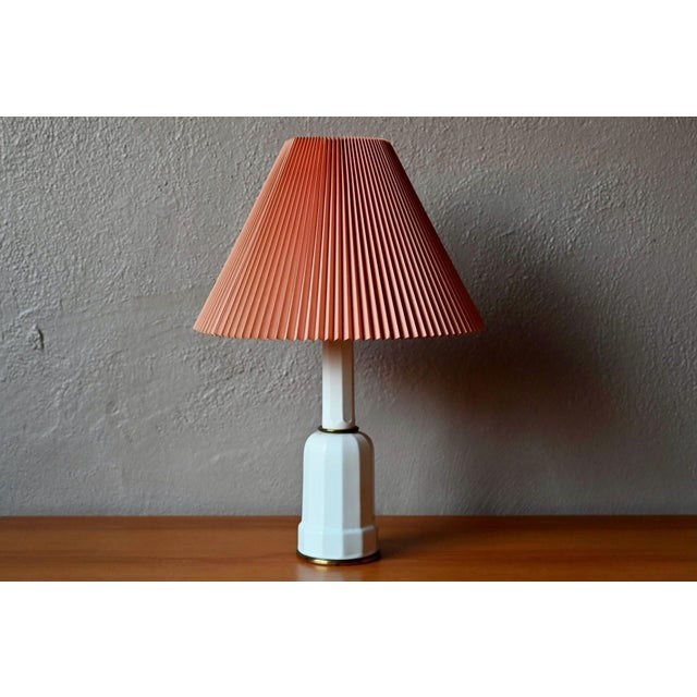A typical Danish lamp, this lovely specimen in white porcelain and brass dates from the 1960s. with its elegant base and...