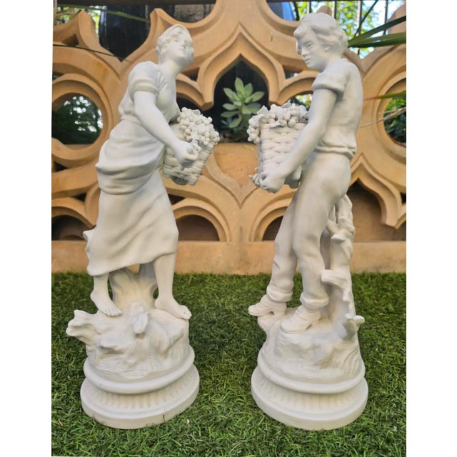 Pair of 19TH C. French Bisque Porcelain Peasant Figures, “Paysan aux Raisins” and “Paysanne aux Raisins,” after Hippolyte...