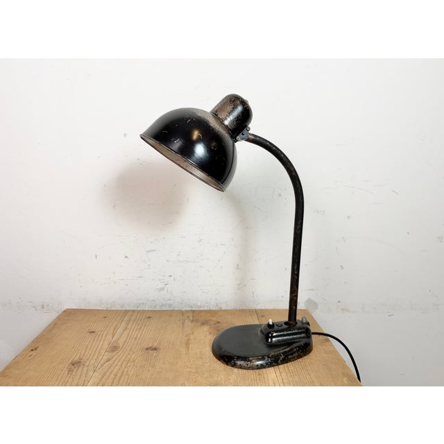 This black Bauhaus industrial desk lamp with two adjustable joints was made in Germany during the 1930s. It features black...