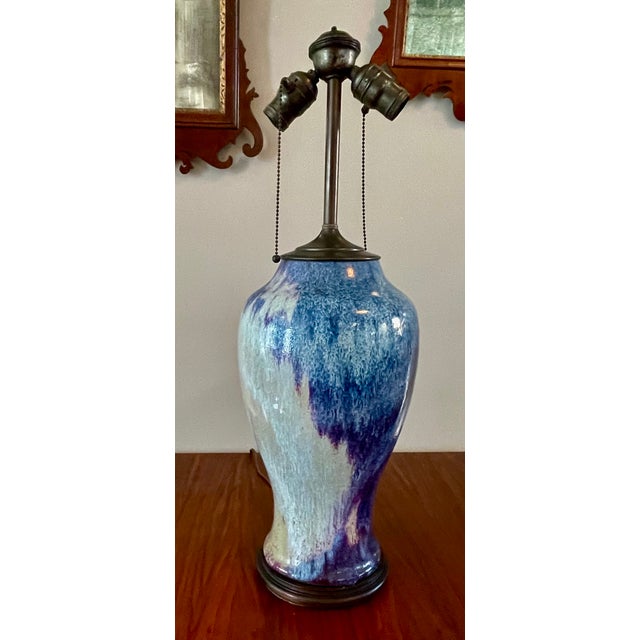 Converted from a Chinese vase with a rich flambé glaze in layered violet, lavender and sky-blue tones, this early/mid...