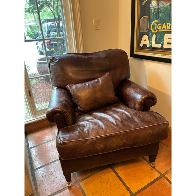 George Smith Leather Club Chair with Brass Casters A timeless George Smith leather club chair upholstered in rich, supple...