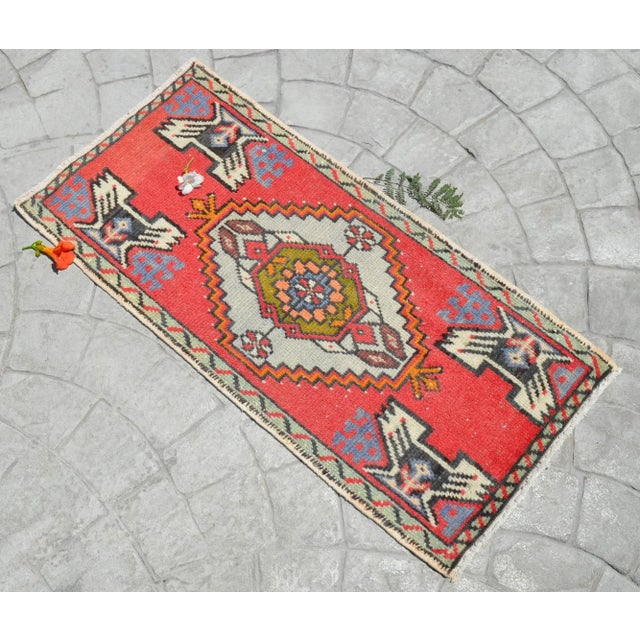 a Vintage Turkish Small yastik rug, vivid red color background yastik rug perfect for entryway, bath or in front of the...
