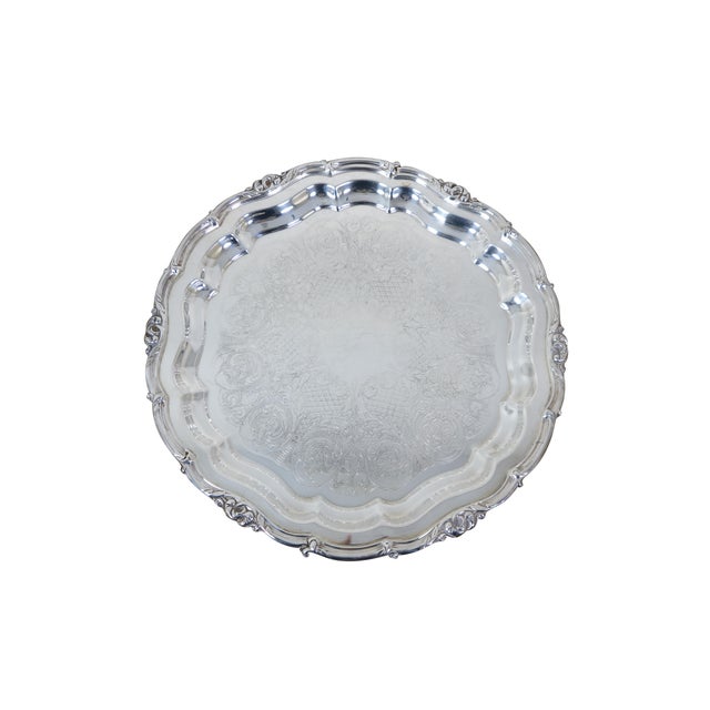 Seven silverplate round / scalloped / pierced / reticulated trays or platters. Makers: Community - Melon, Wilcox -...