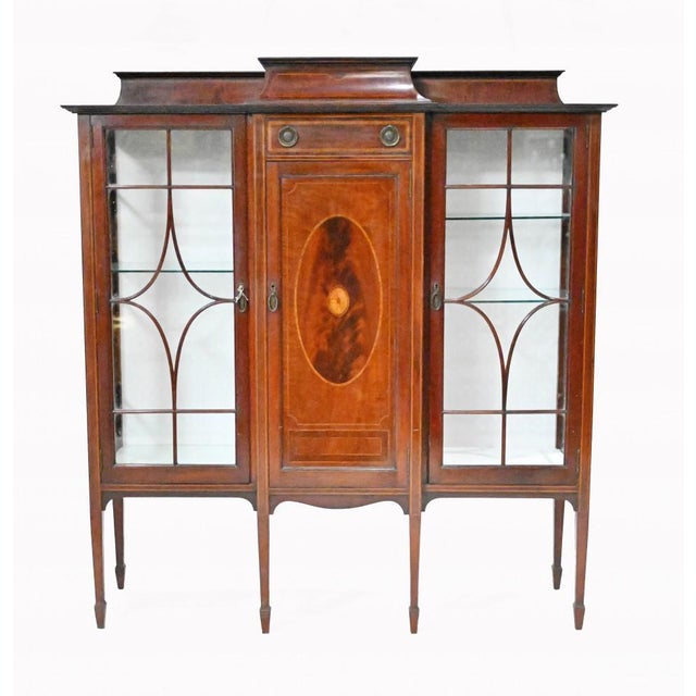 Gorgeous Edwardian display cabinet in the Sheraton manner We date this to circa 1910 and it's crafted from mahogany with...