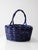 Large vintage painted wicker basket with a woven body and tall arched handle, finished in a classic royal blue. The...
