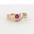 A sophisticated ring featuring a 0.29 carat round-cut ruby of a vivid red color. The ring is accented by 0.31 carats of...