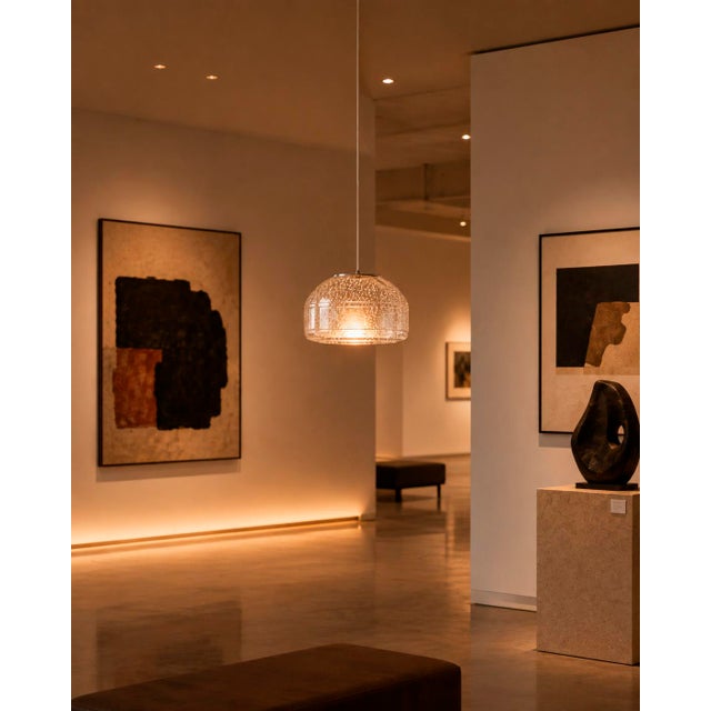Crafted with high visual clarity, this modern pendant lamp features a sleek silhouette hand-blown from premium glass in a...
