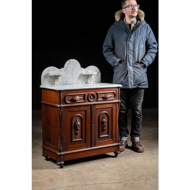 Antique Victorian commode washstand. Crafted from walnut, this piece hearkens back to a time of American craftsmanship in...