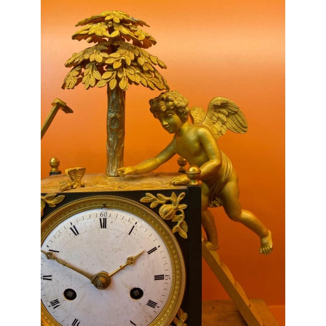 "L''Amour jardinier" is a gilt bronze table clocks with a garden angel and garden decors. The garden angel is on a scale...