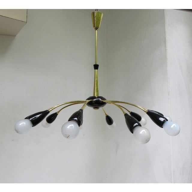 The lamp is made of high-quality polished brass in combination with black painted brass. The lamp has 10 E27 sockets and...
