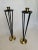 The pair of vintage tall mid century modern style candlesticks are comprised of painted black metal and polished brass in...