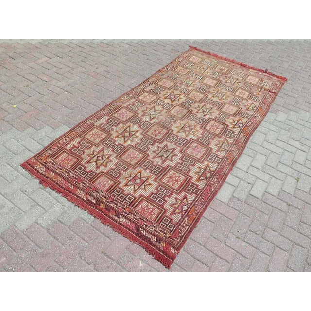 This beautiful, traditional vintage, flatweaved Turkish kilim rug is approximately 60 years old. It is handmade of very...