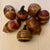 A striking set of seven vintage hand painted gourds, each finished in warm earth tones and bold geometric motifs. The...