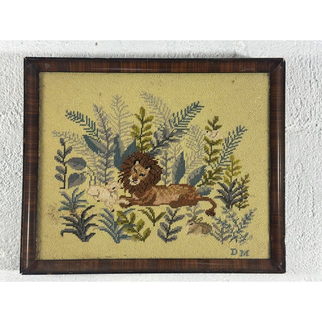 This charming framed needlepoint depicts a peaceful biblical scene of the lion and the lamb resting together among lush...