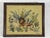 This charming framed needlepoint depicts a peaceful biblical scene of the lion and the lamb resting together among lush...