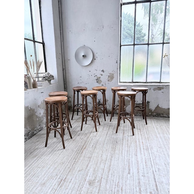 Set of 8 Baumann-style bistro bar stools. Made of walnut, we love their color and overall look. They show signs of age and...