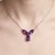 Gracefully designed with a floral-inspired silhouette, this elegant pendant features a stunning arrangement of Amethyst...