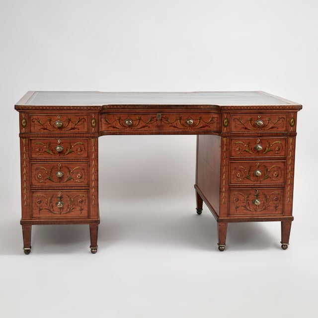 Handsome English Adams style desk crafted in mahogany having a tooled leather top on a double pedestal with nine drawers...