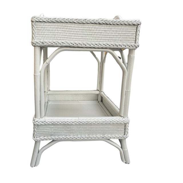 Add charm and function to your space with this vintage-inspired 2-tier woven rattan bar cart in a soft white finish. The...