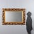 Baroque-style carved and gilded mirror, dating back to the early 20th century, made in Italy. The molded frame features an...