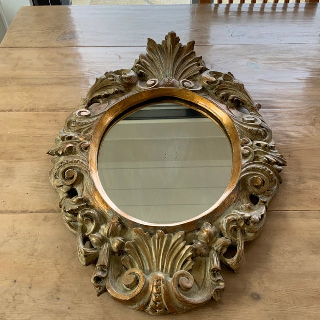 Beautifully carved wooden mirror with frame carved “Made in Italy” under the wooden-backed mirror. A truly lovely piece,...