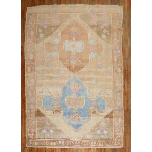 A room-size geometric Turkish kars rug from the 3rd quarter of the 20th century with 2 large brown medallions on a khaki...