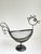 Add a touch of playful, mid-century charm to your kitchen or dining room with this unique, abstract wire rooster basket....