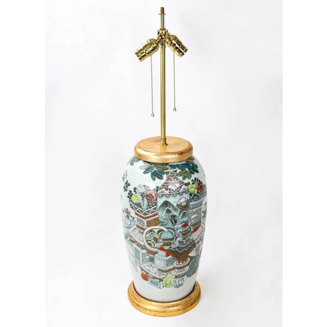 18th century Famille Rose Vase Lamp（Double lights table lamp) with metal gold leaf on top and base. The pattern is...
