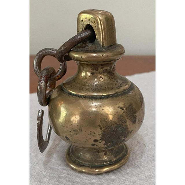 A set of antique Greek brass weights. The largest one is a 2 1/2 pound weight and the other two are each a 1 pound weight....