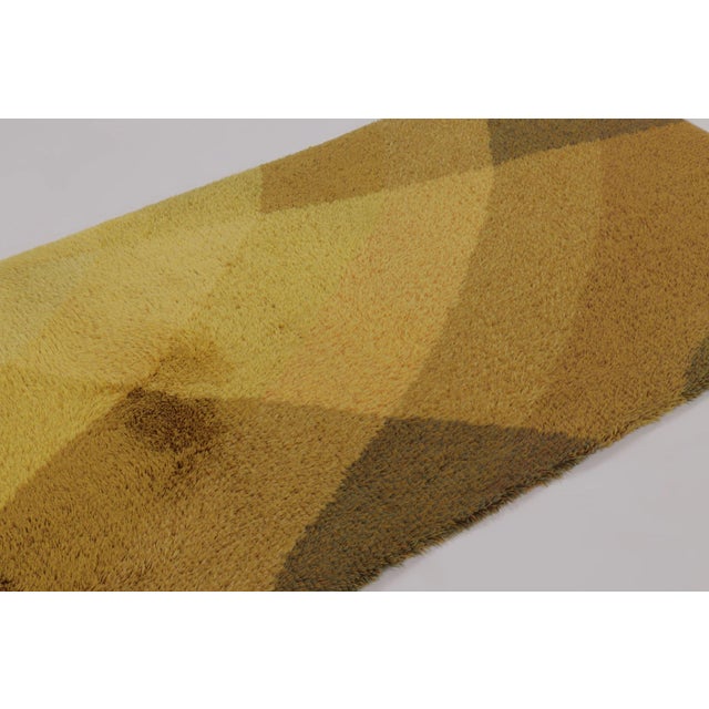 Hand-knotted in lush, high-pile wool in Sweden circa 1960-1970, this 4x6 vintage Swedish Rya rug is a bold new addition to...