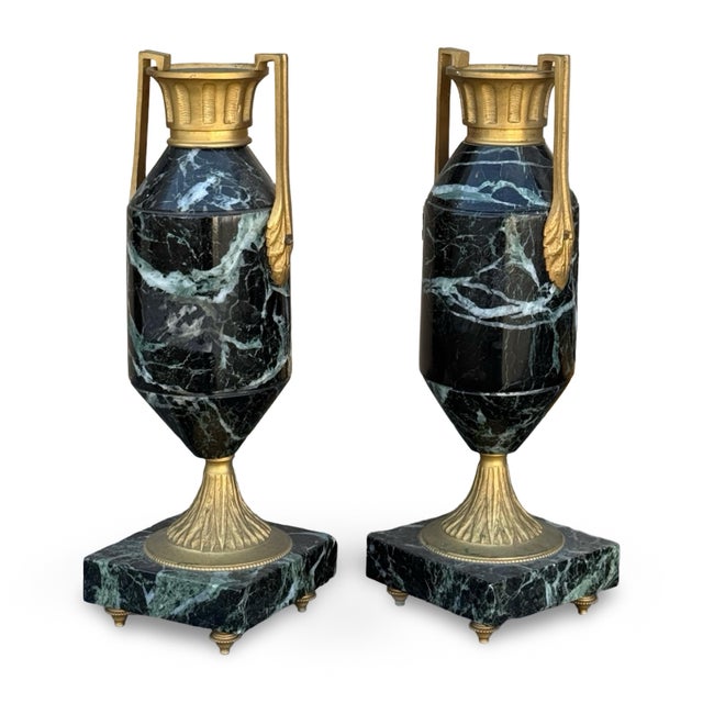 Matching pair of late 19th-century French Neoclassical urns crafted from marble with gilt-bronze ormolu mounts. Each...