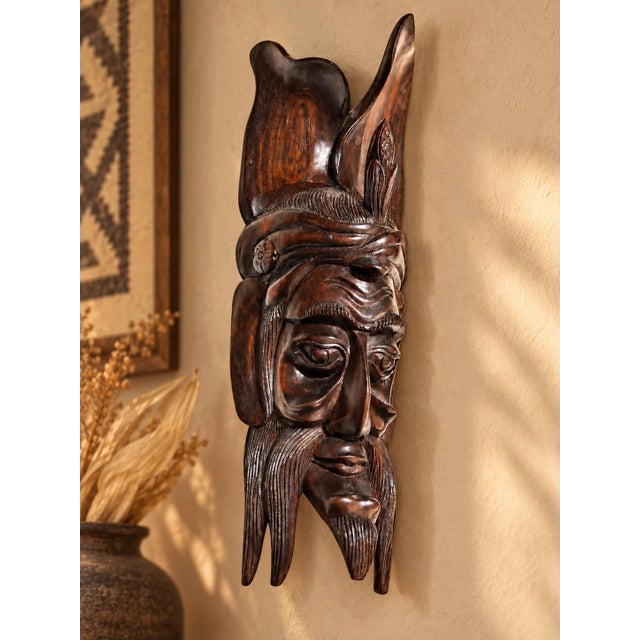 An exceptionally sculptural vintage hand-carved hardwood wall mask inspired by the Maya Maize God, or Corn God, an...