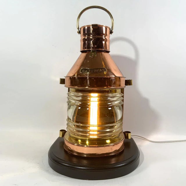Highly polish and lacquered ship's masthead lantern. With clear Fresnel glass lens. Vented top, brass carry handle....