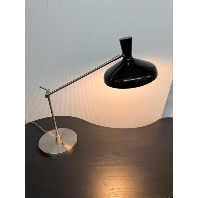 Design Plus Gallery presents a Cantilever Table Lamp with Black Adjusting Light Source. The lamp has a design that is...