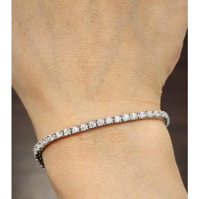 This gorgeous tennis bracelet is a remarkable piece. Featuring 2.77 carats of round-cut diamonds, each stone is a...