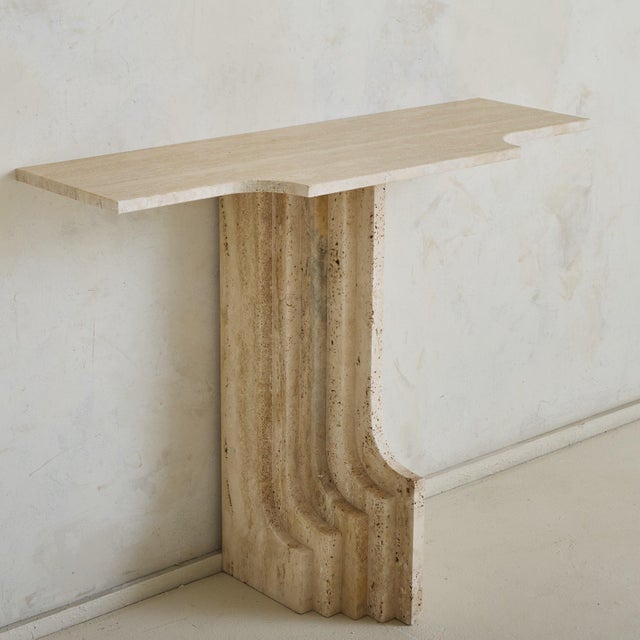 Sold and priced individually. This 1970s Italian travertine console embodies the sculptural ethos of Carlo Scarpa. The...