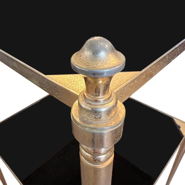 This is a super stylish pair of Jansen style midcentury side tables. Made in France from gilt metal and black glass. A...