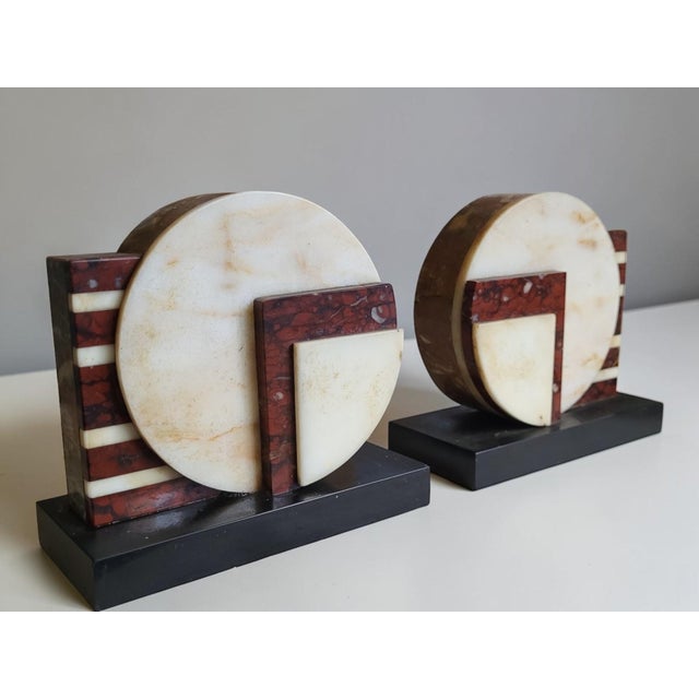 Pair of Art Deco Geometric Bookends in Two-Tone Marble — France, 1930s A beautiful pair of Art Deco bookends with a...