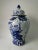 This blue and white porcelain jar is adorned with hand painted blooming flowers and flying birds. Antiquing process...