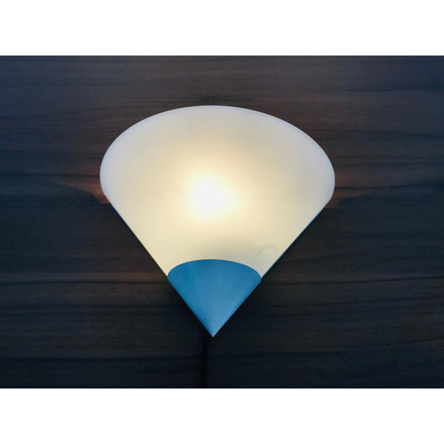 A beautiful Mid-Century Modern wall lamp by Glashütte Limburg made in Germany in the 1970s. It has a beautiful triangle...