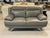MODERN GRAY LEATHER LOVESEAT WITH METAL BASE -Matching gray leather loveseat featuring plush cushioning, wide arms, and a...
