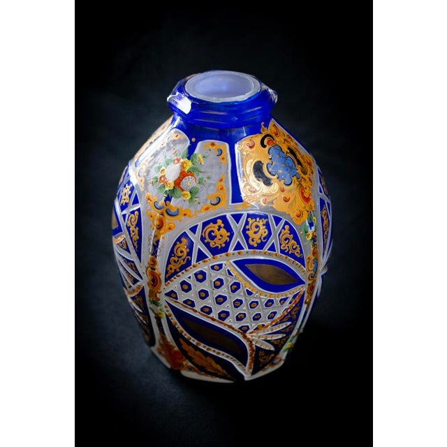 A flattened ovoid vase in cobalt blue overlay crystal on white, cut with geometric facets—medallions, radiating shuttles,...