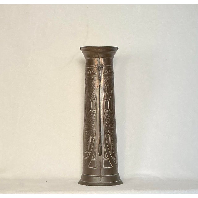 Tall Art Nouveau copper tapered vase with a medieval fusion to its design and has brass handle detailing. From the 1800's...