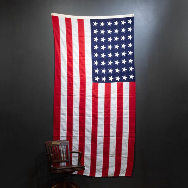 ABOUT An original American flag with 48 sewn stars and stripes and brass grommets. CREATOR Valley Forge Flag Co. DATE OF...