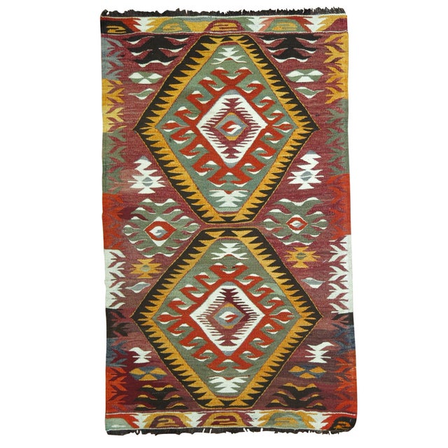 Rustic colored geometric mid-20th century Turkish Kilim throw rug, circa mid-20th century. Measures: 2'6” x 4'4”.