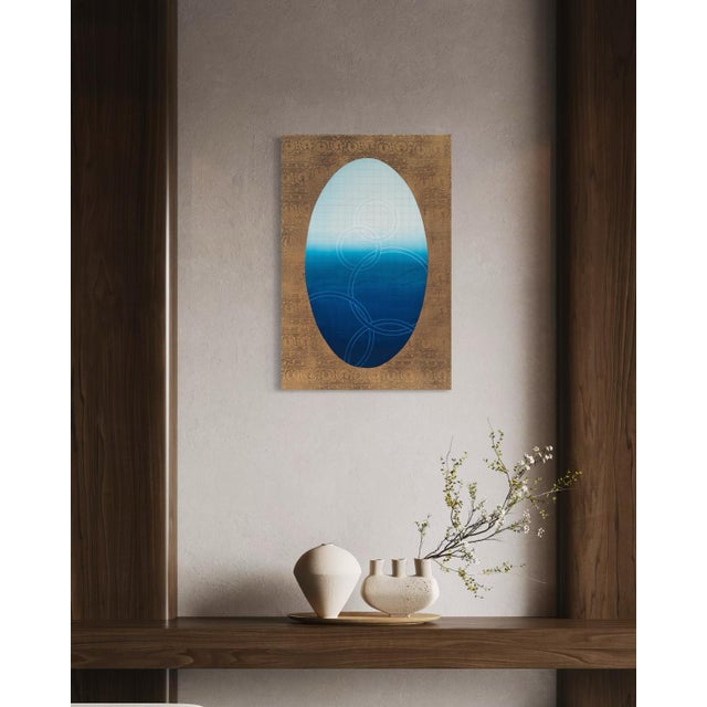 This oval deepens from a soft, hazy powder blue at the top into a rich, almost navy blue at its base, the transition...