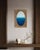 This oval deepens from a soft, hazy powder blue at the top into a rich, almost navy blue at its base, the transition...