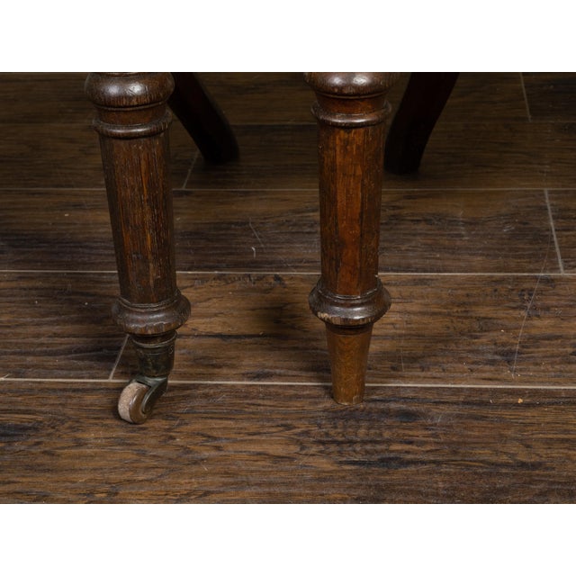 A pair of English Regency style oak Klismos chairs from the 19th century, with carved scrolling decor, geometric inlay and...