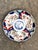 Antique Japanese Imari plate. Blue and white blades of grass center with red blue and white panel details.