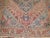An early 20th Century room size colorful Persian Heriz rug with a medallion and border design on a red field....